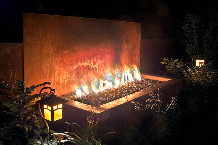 Lighting and a fireplace make your winter landscape more inviting. In Harmony Sustainable Landscapes