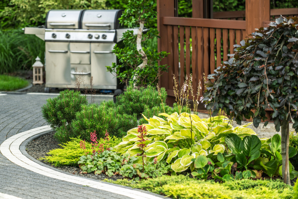 Patio, perennial plantings, grill. In Harmony Sustainable Landscapes